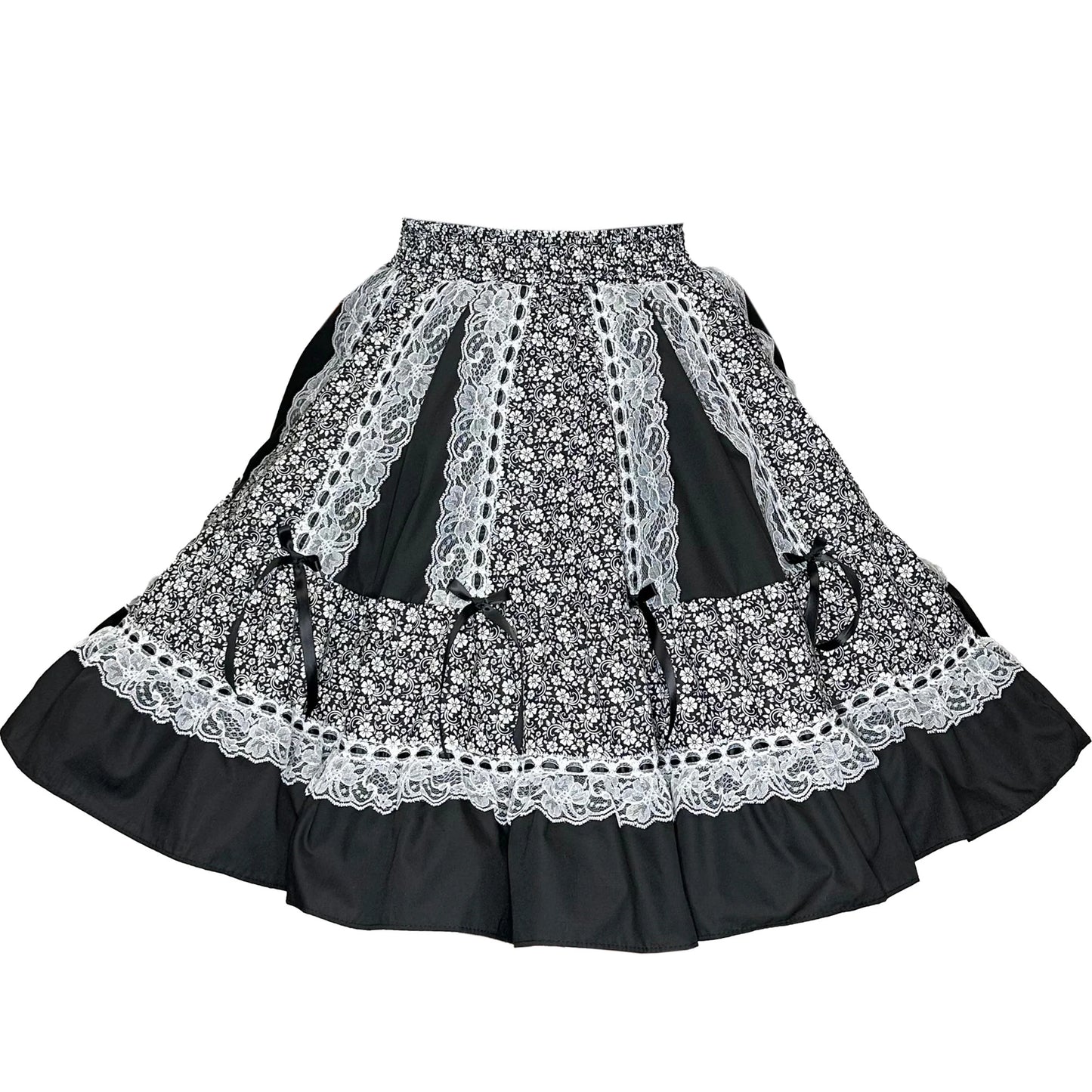 The Black Elegant Ruffled Square Dance Skirt by Square Up Fashions features black-and-white floral print, ruffled hem, lace trim, and ribbon accents—ideal for square dance—displayed on a plain white background.