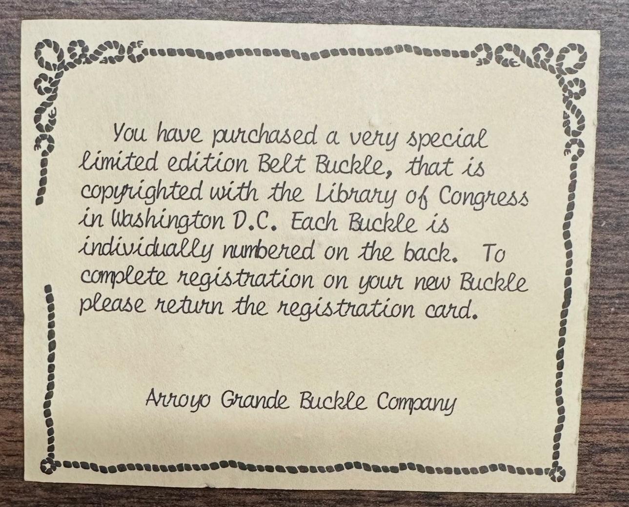 A printed note explains how to register the Square Dance Buckle w/ instruments from Square Up Fashions, highlighting its limited edition status, individual numbering, and copyright.