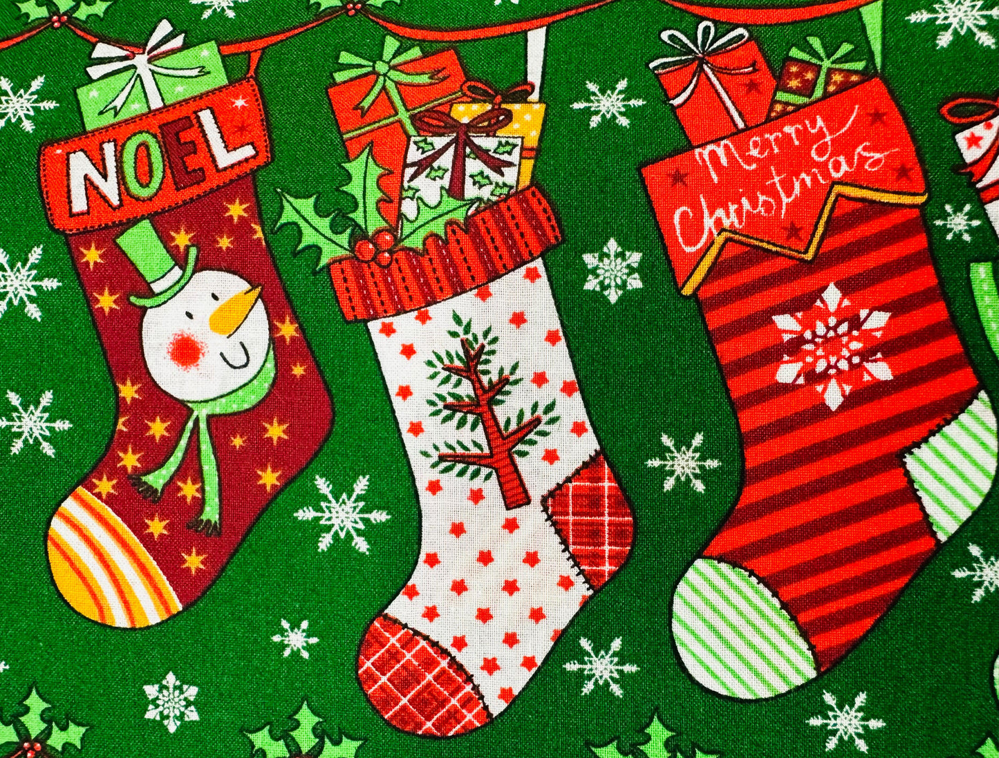 The Christmas Stockings Square Dance Outfit by Square Up Fashions features festive stockings with gifts, holly, and "NOEL/Merry Christmas" on green with snowflakes—a whimsical inspiration for your holiday skirt or ensemble.