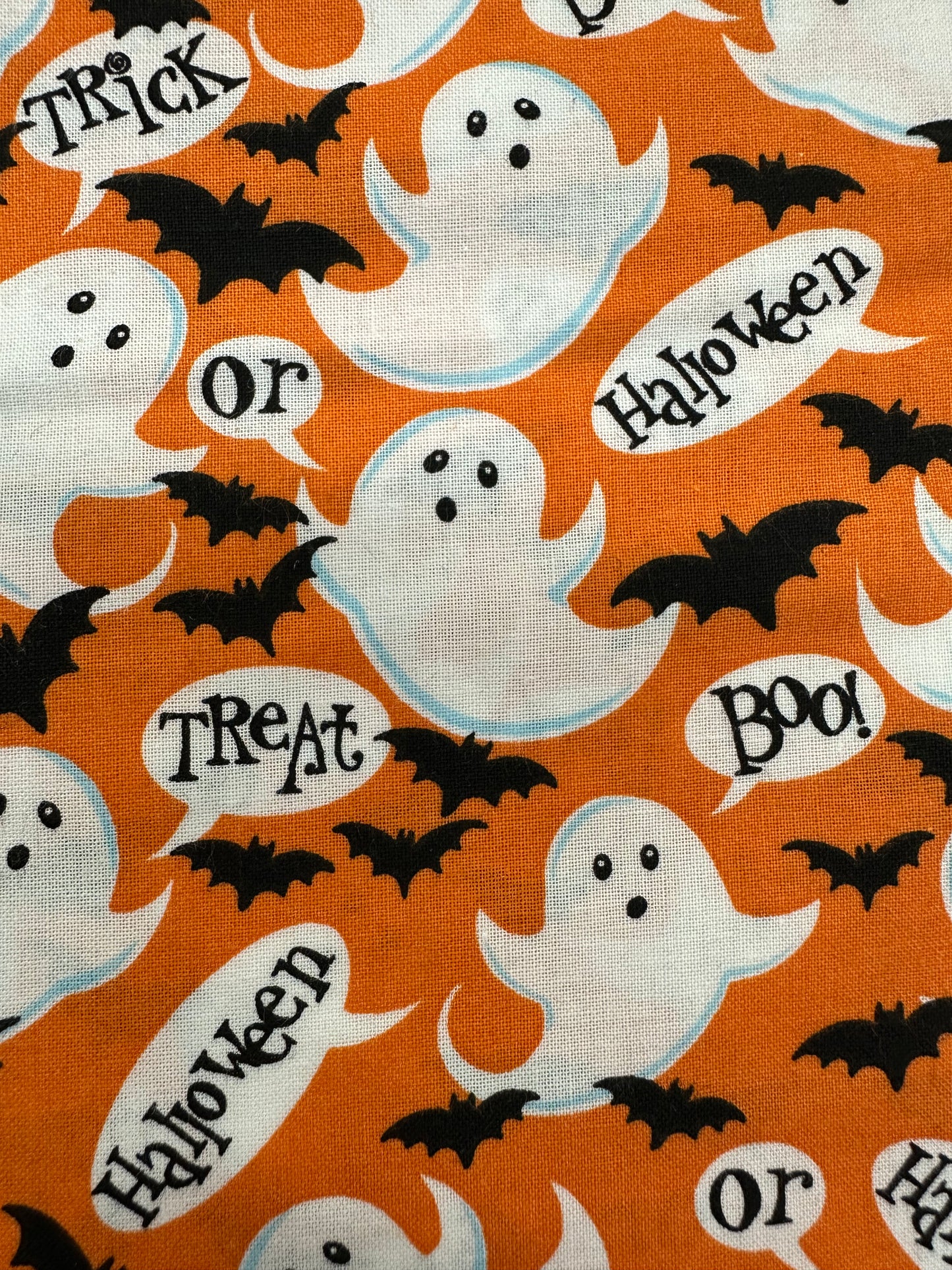 The Ghostly Square Dance Outfit by Square Up Fashions features a festive orange skirt with white ghosts, black bats, and speech bubbles saying "Trick," "Treat," "Halloween," and "Boo"—perfect for Halloween.