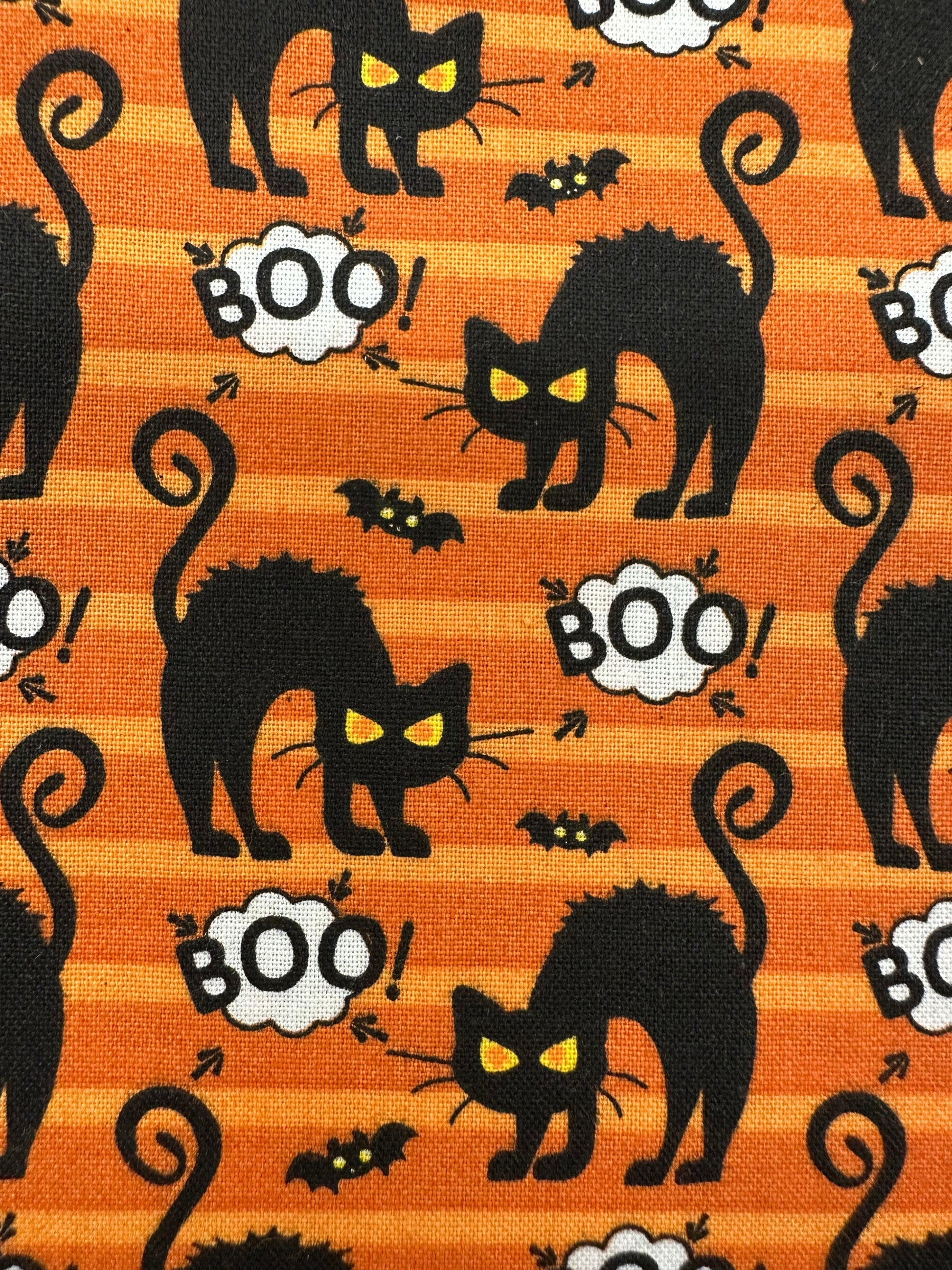 The Scared-y Cat Square Dance Skirt by Square Up Fashions features arched-back cats, yellow eyes, bats, and "BOO!" on orange and yellow stripes—perfect for Halloween or festive square dance looks.