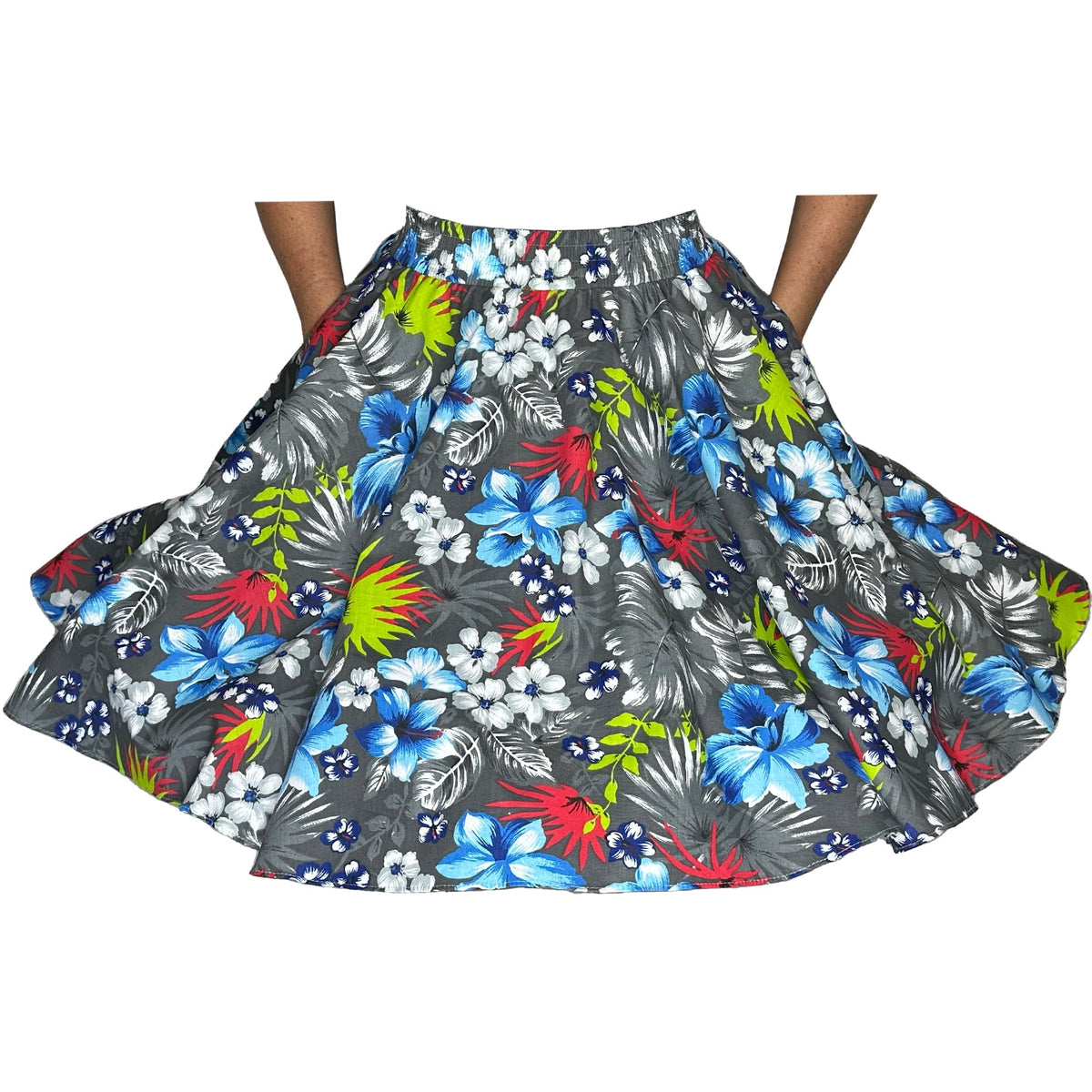 A person holds out a Square Up Fashions Tropical Hawaiian Square Dance Skirt with a gray background and colorful Hibiscus flowers, including blue, white, and red blossoms.