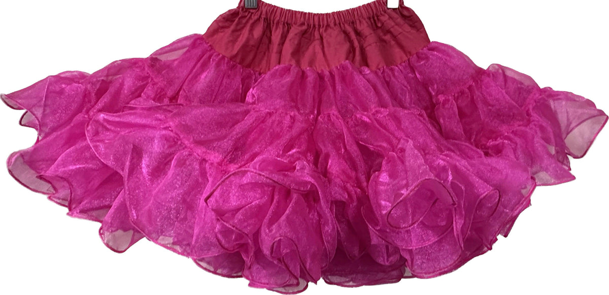 An adjustable pink CLEARANCE Childrens Crystal Petticoat made of nylon crystal fabric, hanging on a hanger by Square Up Fashions.