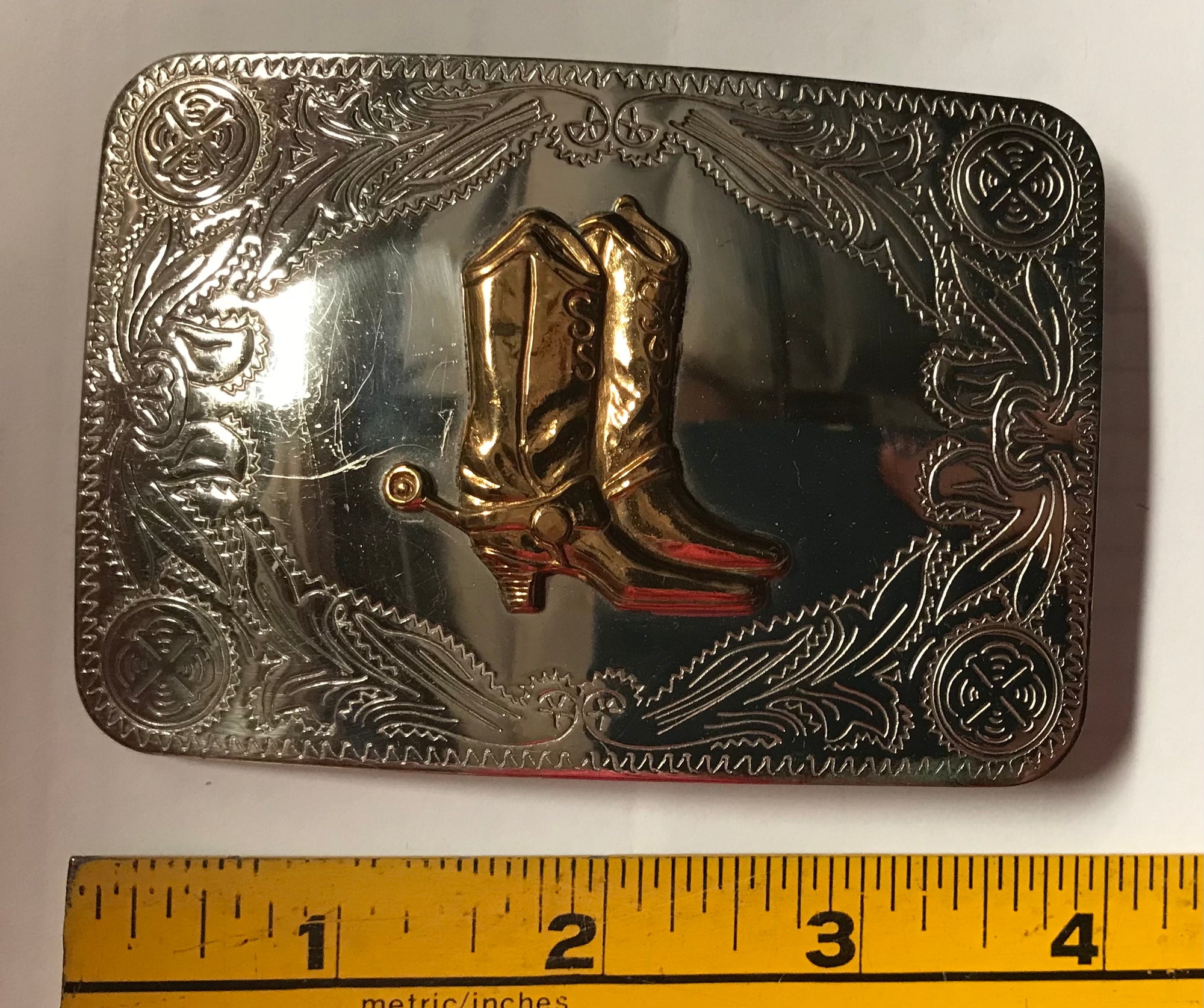 A Square Dance Buckle featuring a cowboy boot design by Square Up Fashions.