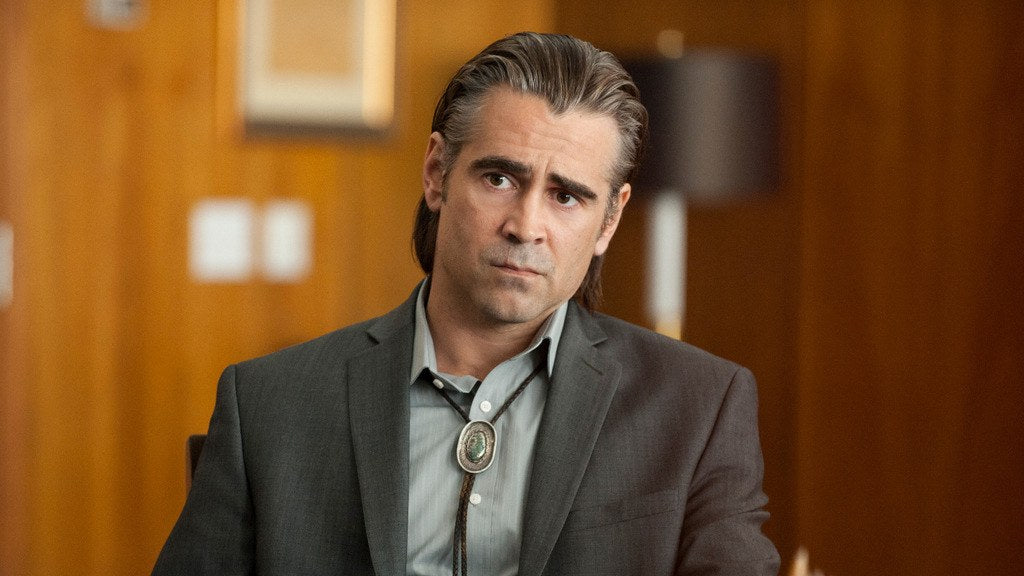 Man in a suit jacket wearing a silver bolo tie