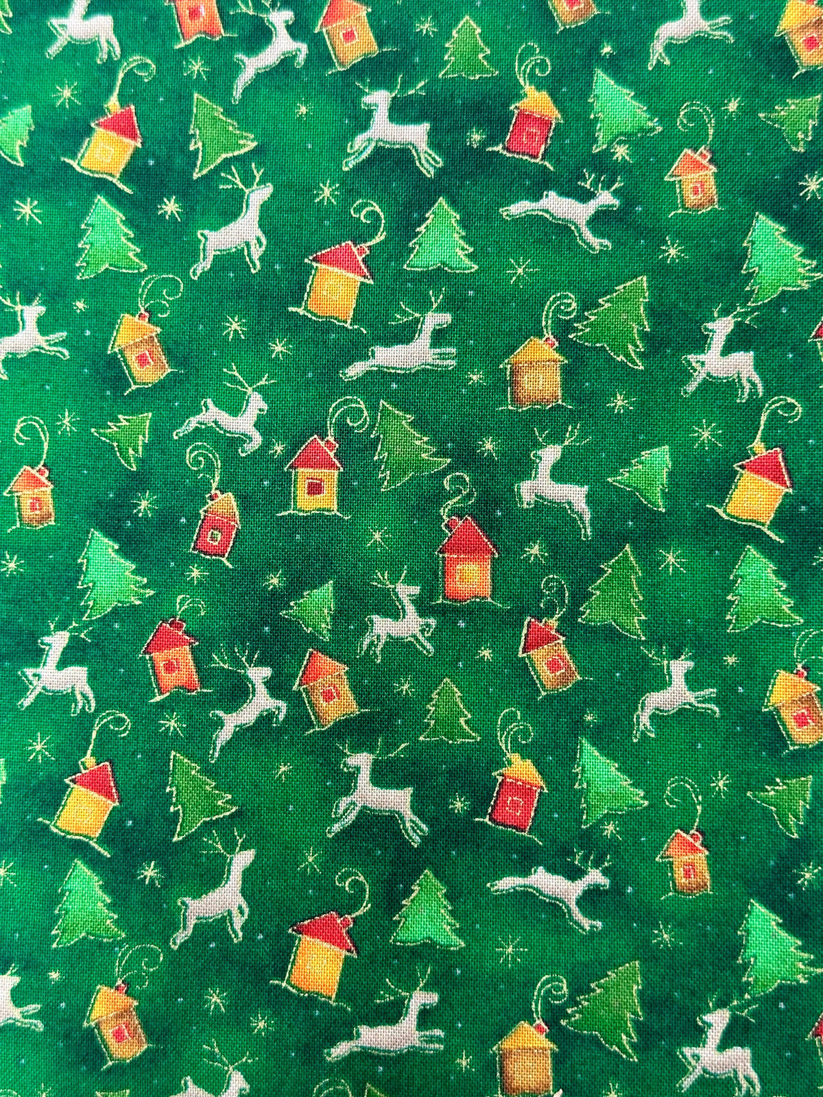 A green fabric with deer and houses on it, perfect for a Reindeer Square Dance Skirt from Square Up Fashions.
