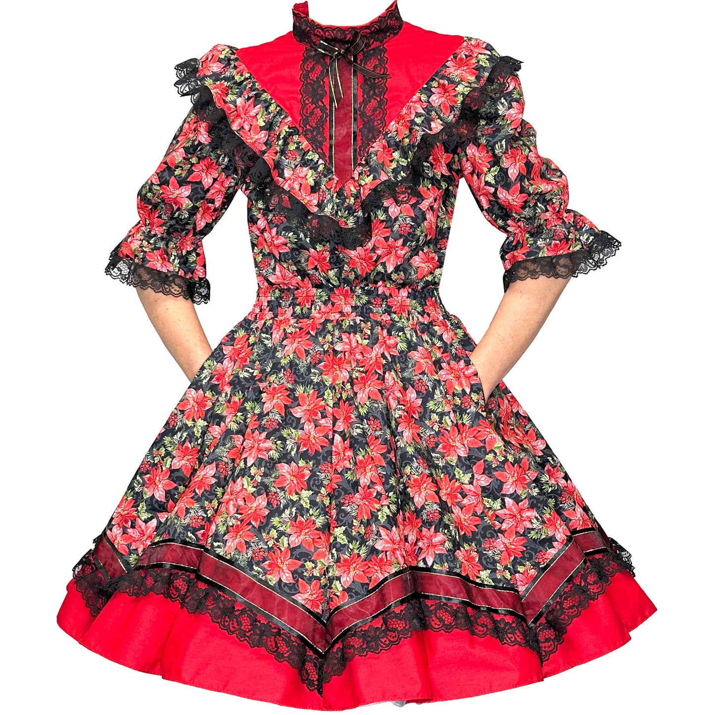 The Holiday Poinsettia Square Dance Outfit by Square Up Fashions features red and black poinsettia prints, black lace trim, ruffled details, and elbow-length sleeves—perfect for festive holiday events.