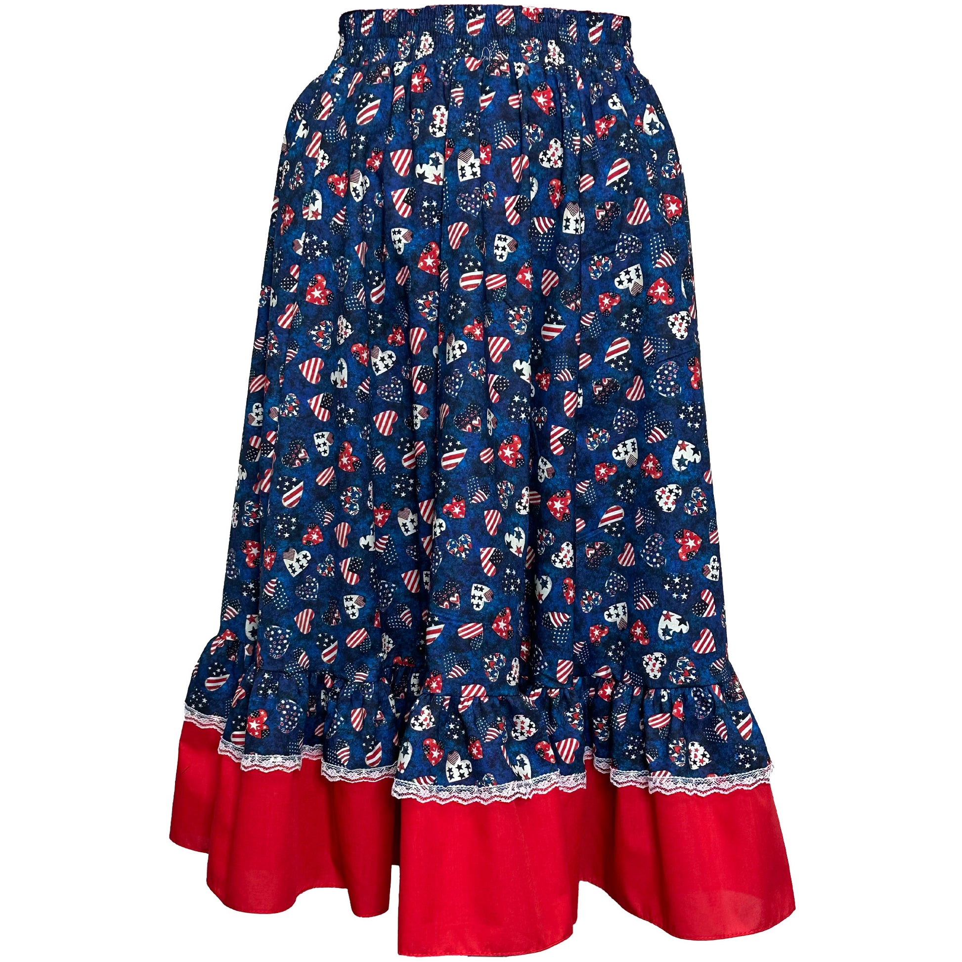 The Americana Prairie Skirt by Square Up Fashions features blue fabric with red ruffled hem, decorated with red, white, and blue stars, flags, and hearts—ideal for 4th of July or festive patriotic looks.