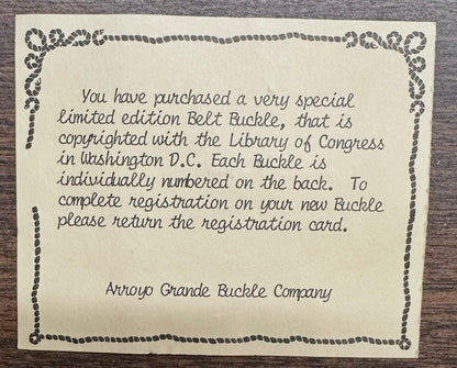 A printed note explains how to register the Square Dance Buckle w/ instruments from Square Up Fashions, highlighting its limited edition status, individual numbering, and copyright.