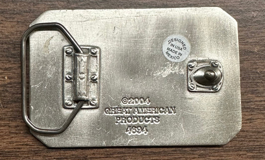 Back of the Square Up Fashions Music Note Belt Buckle, featuring a metal loop, hook, engraved text, and a sticker that says "DESIGNED IN USA MADE IN MEXICO.