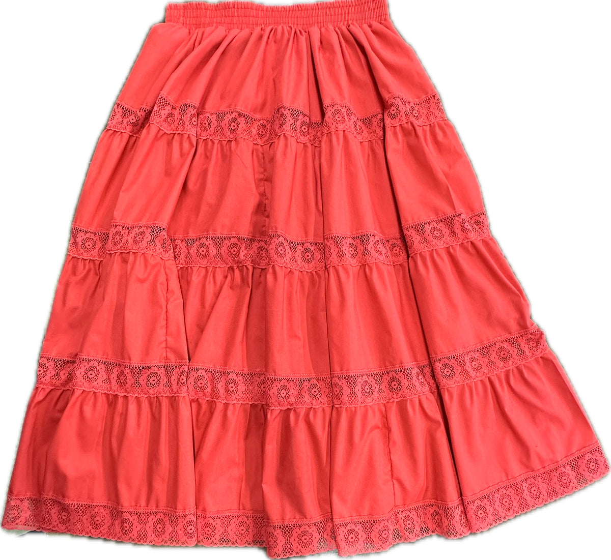 The Square Up Fashions 4 Tier Lace Prairie Skirt is a coral skirt with lace trim, an elastic waistband, and gathered fabric for a tiered look.