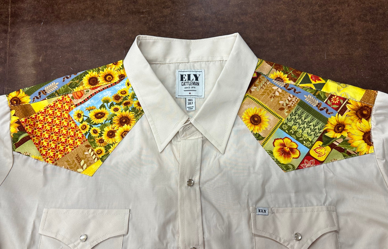 A MATCHING Print Yoke and/or Cuffs (shirt NOT included) by Ely Shirts, designed in beige with vibrant patchwork floral and sunflower patterns for the shoulder yokes.