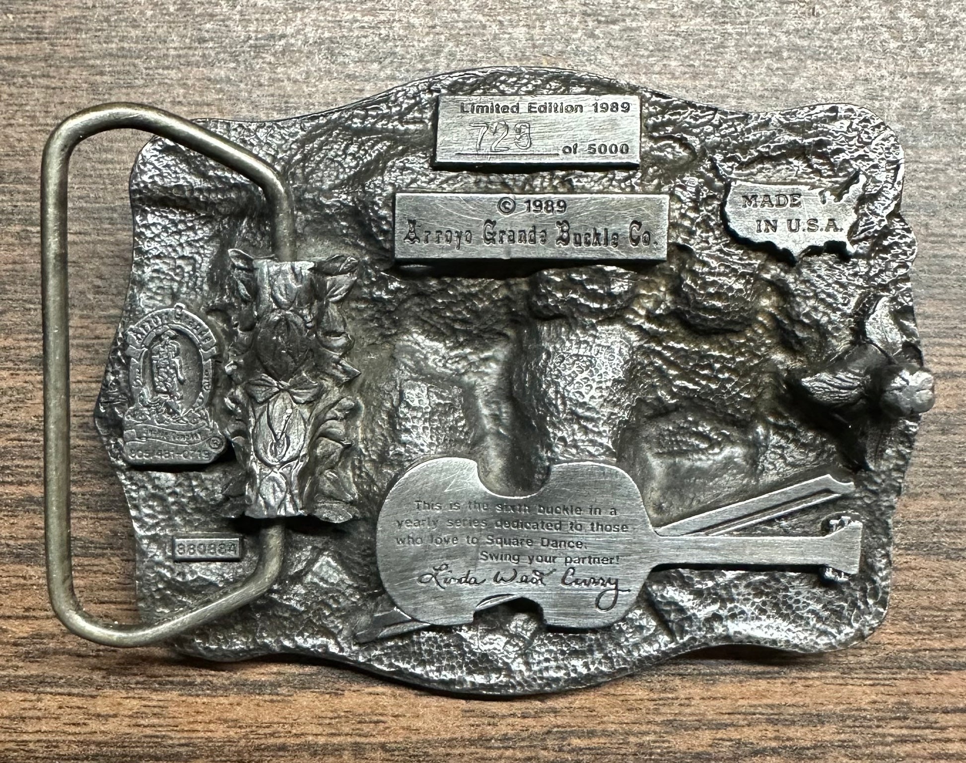 This limited edition Square Dance Buckle w/caller by Square Up Fashions, number 1298 of 5000, features engraved text, a guitar, sculpted details, and vintage style—a special collector's item made in the USA.
