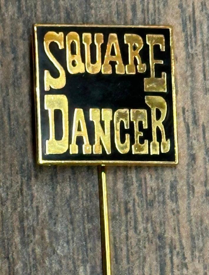 The Square Dancer Stick Pin by Square Up Fashions features "SQUARE DANCER" in bold on a black and gold rectangular background—an ideal jewelry accessory for any square dancer.