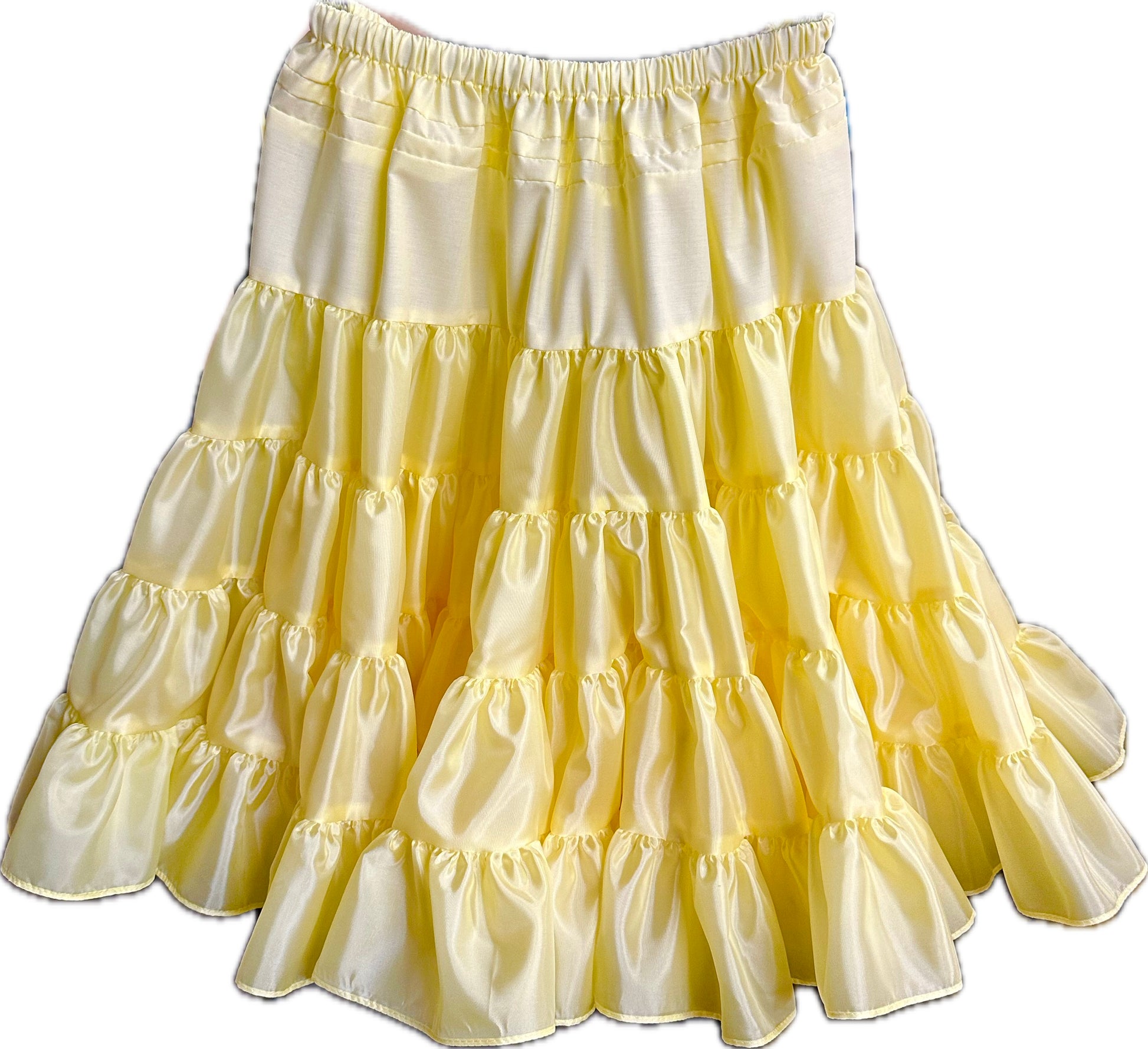 The Soft Poly-Liner Petticoat by Square Up Fashions is a knee-length yellow polyester petticoat with ruffled tiers and an elastic waistband—ideal for square dancing or as an adjustable slip under your dress.