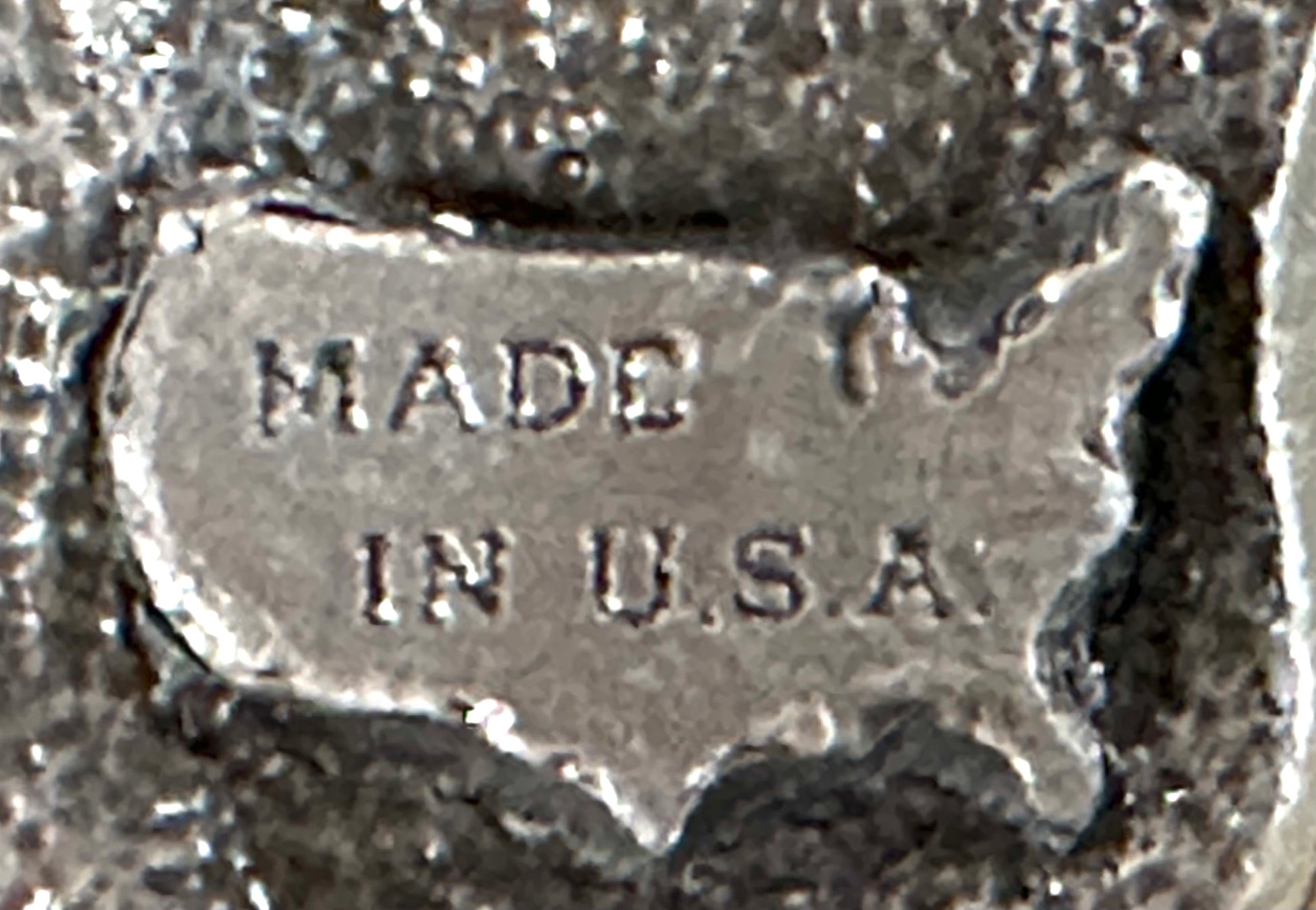 The Square Up Fashions "Square Dance Buckle w/ instruments" is a metal buckle featuring musical designs, reminiscent of a vintage square dance accessory from the 1988 Anaheim National event.