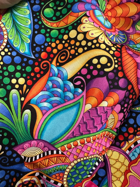 A close-up of the Colorful Carnival Square Dance Skirt by Square Up Fashions, showcasing bold pinwheels, dots, and intricate abstract patterns on black—ideal for lively Carnival outfits or diagonally cut skirt gores.