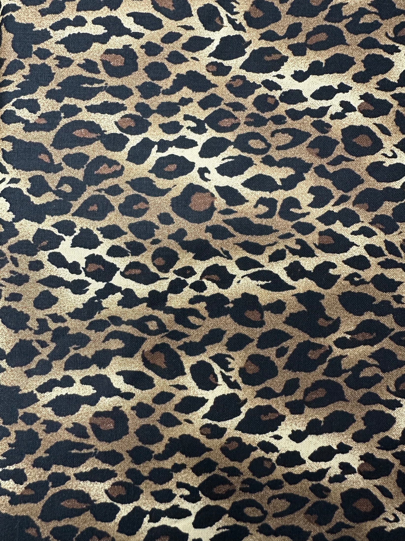 Close-up of the Wild Animal Print Skirt by Square Up Fashions, showcasing black and brown leopard spots on a tan background—perfect for adding bold flair to your square dance outfit.