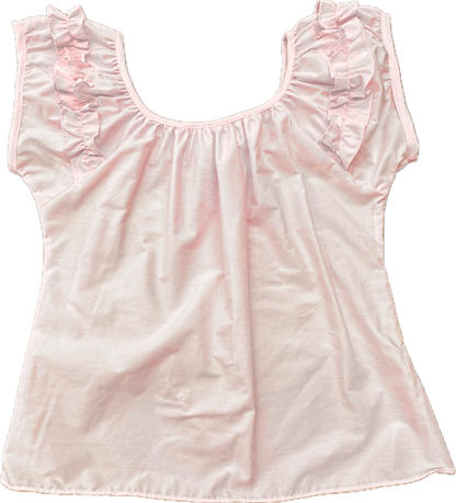 The Basic Ruffle Blouse by Square Up Fashions features light pink fabric, shoulder ruffles, a scoop neck, and cap sleeves. Shown laid flat on a white background, this vintage-inspired blouse offers a loose fit and is available in custom sizes.