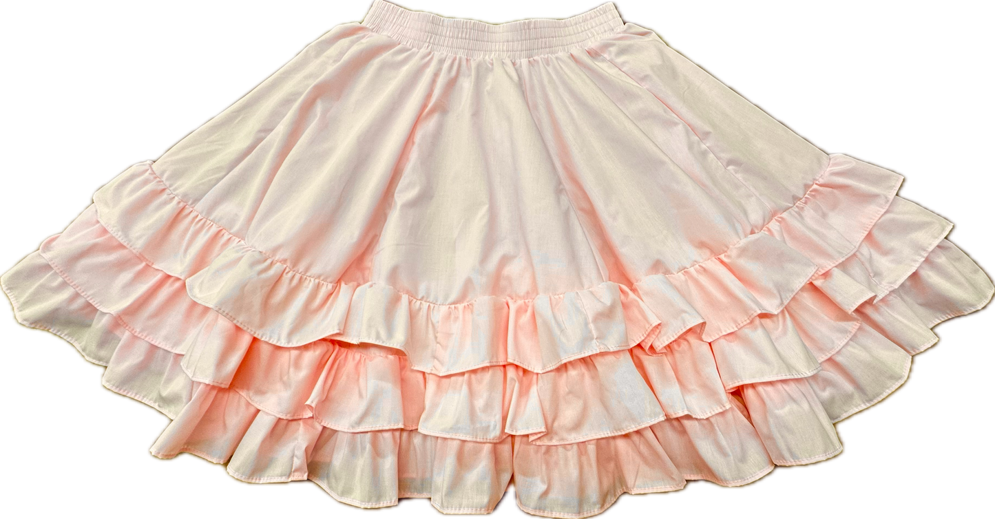 The Square Up Fashions 3 Ruffle Square Dance Skirt is a light pink skirt with three ruffle layers and an elastic waistband, shown laid flat on a white background. Custom sizes available for the perfect fit.