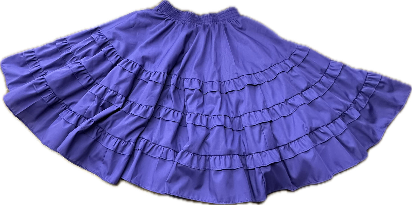 The Double Ruffle Square Dance Skirt by Square Up Fashions, featuring double ruffles and an elastic waistband in purple, is spread out on a light background.