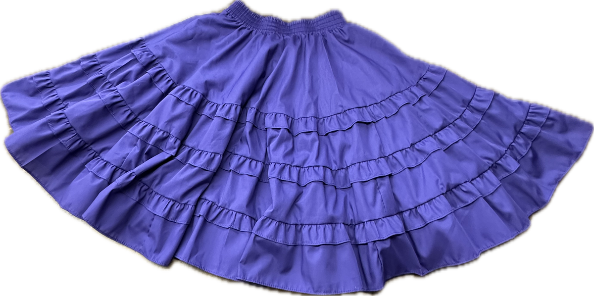 The Double Ruffle Square Dance Skirt by Square Up Fashions, featuring double ruffles and an elastic waistband in purple, is spread out on a light background.