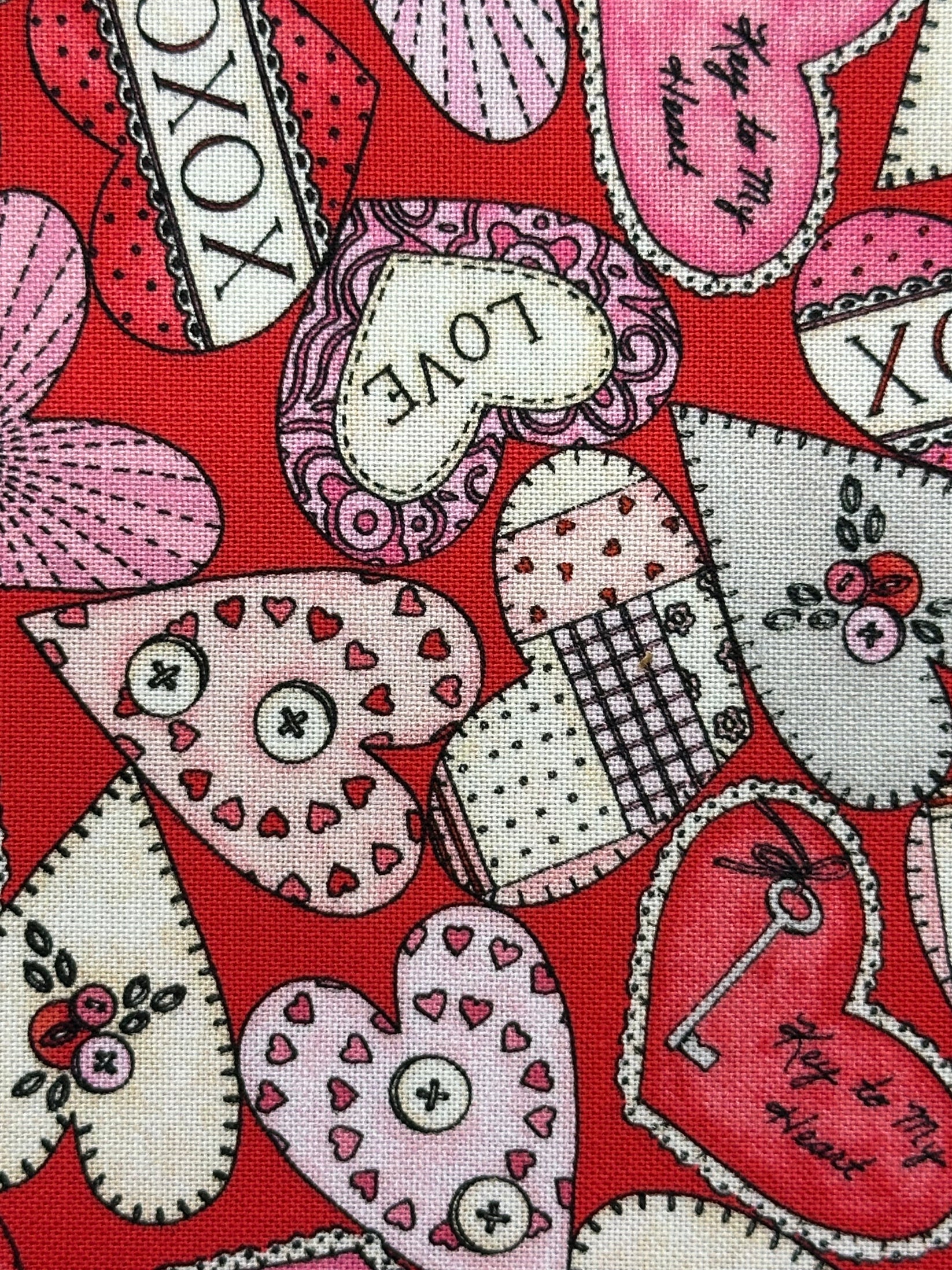 The I Heart You Skirt Square Dance Skirt by Square Up Fashions features pink and red heart patterns, decorative stitching, buttons, and "LOVE" and "XOXO" text on a red background—ideal for crafting a charming heart print skirt.