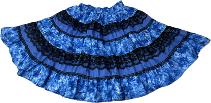 The Tone on Tone Square Dance Skirt by Square Up Fashions is a wide, blue, ruffled tiered skirt with black lace trim shown flat on a white background.