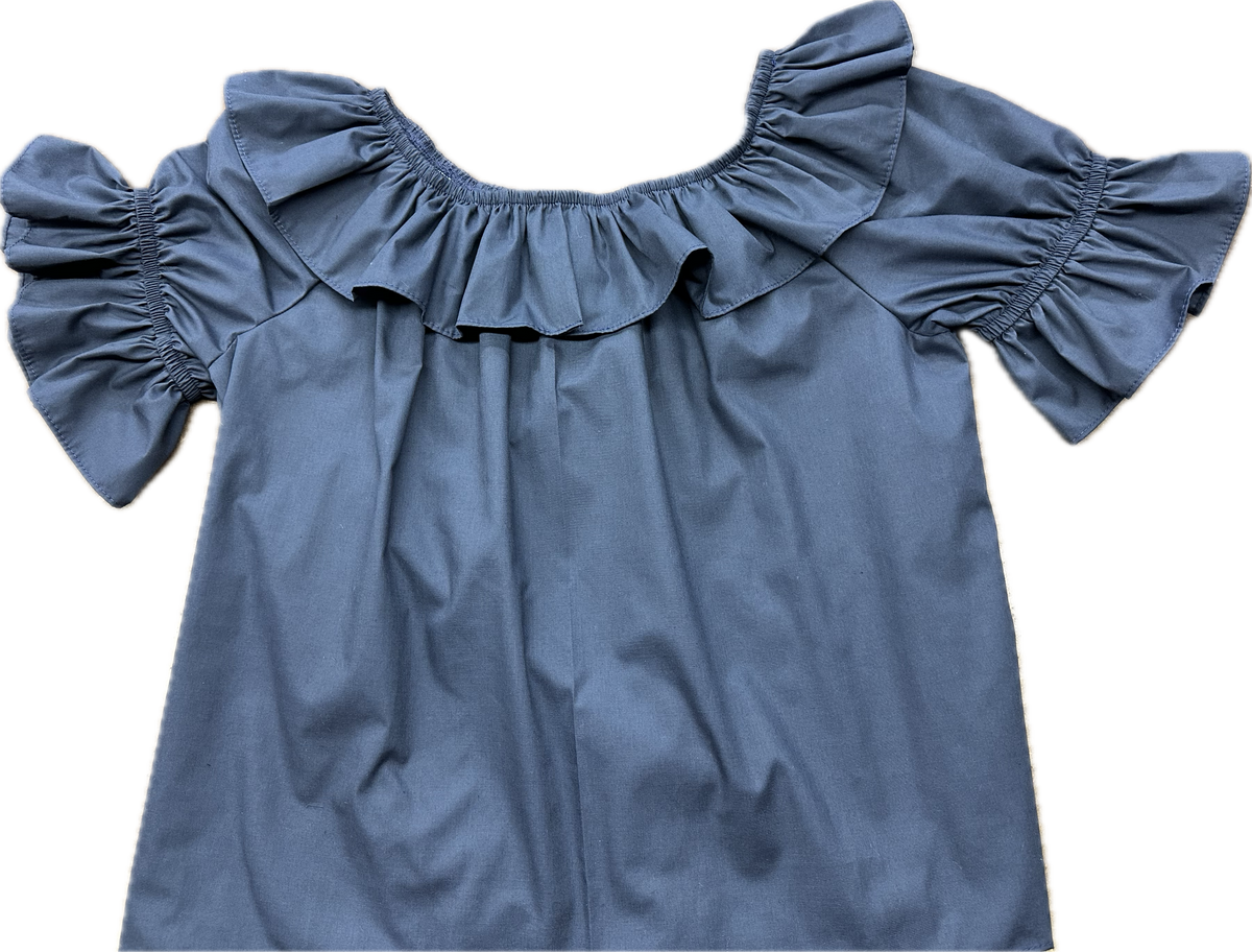 A Scoop Neck Blouse from Square Up Fashions with ruffles on the shoulders.