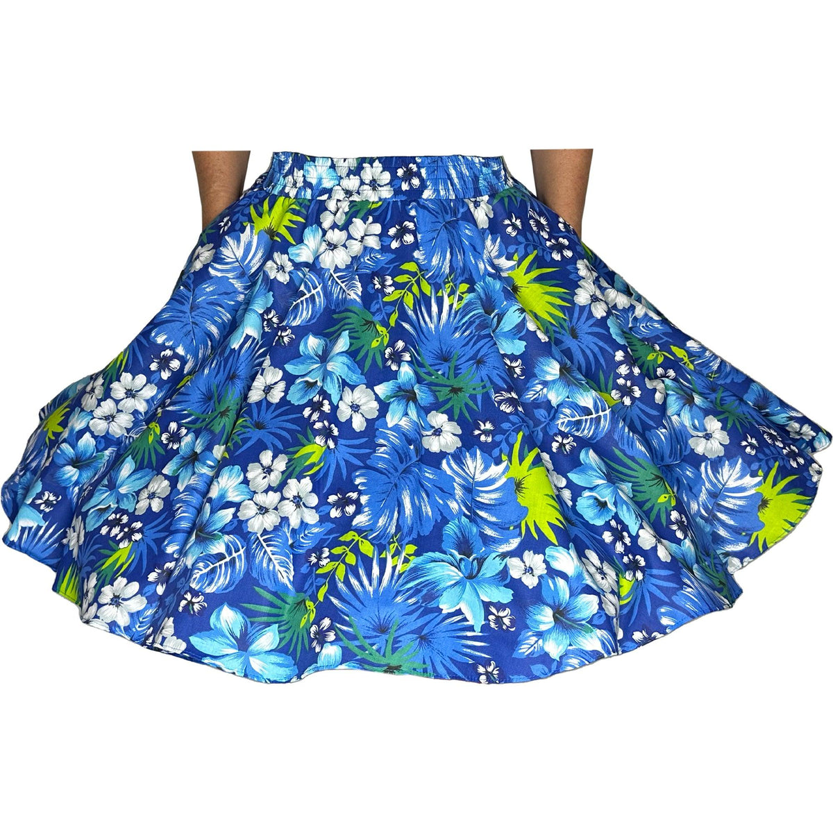 A woman wearing a Tropical Hawaiian Square Dance Skirt adorned with hibiscus flowers and palm leaves made by Square Up Fashions.