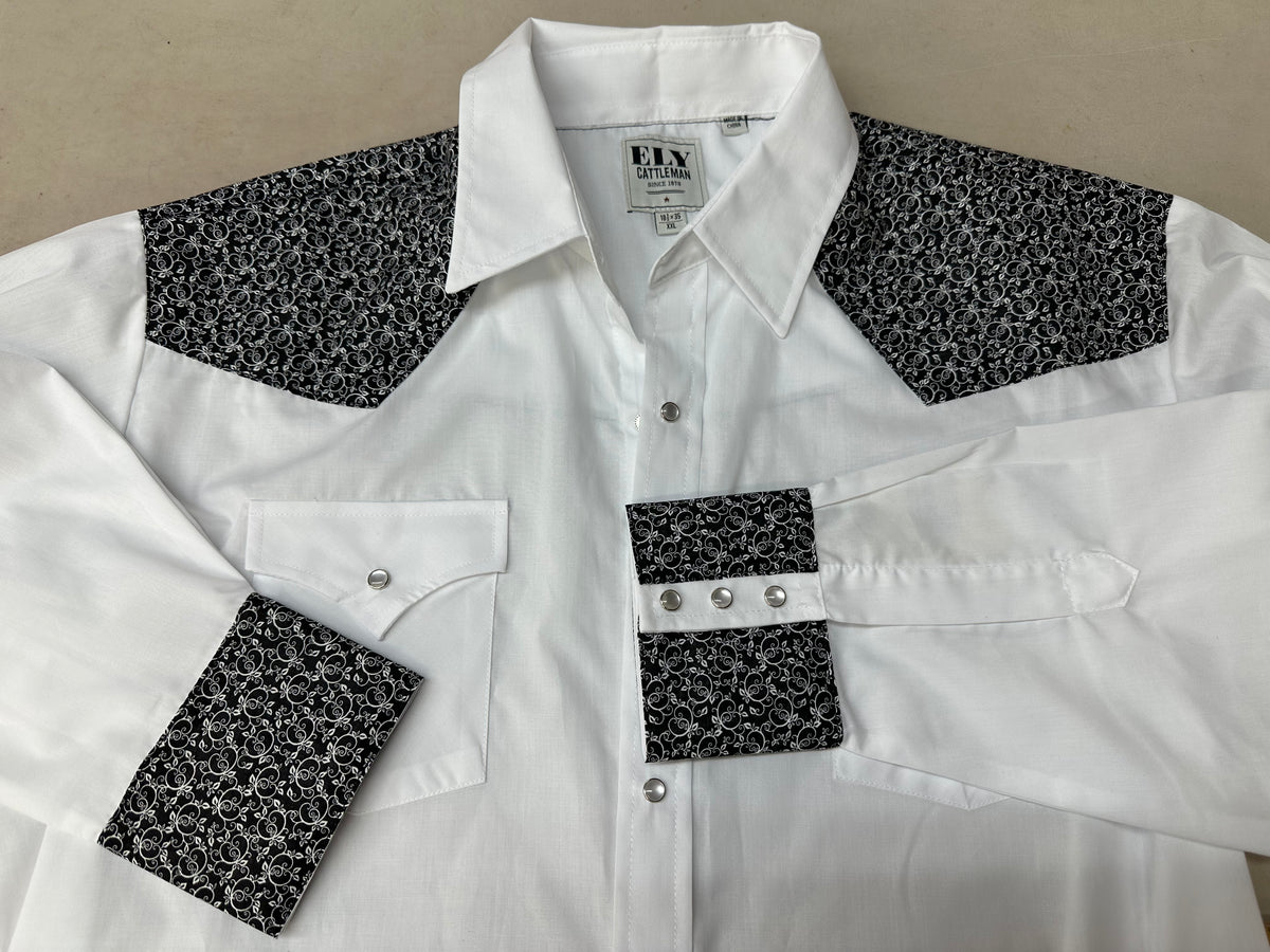 A white shirt with black and white Ely Shirts embroidered cuffs featuring a yoke on the back.