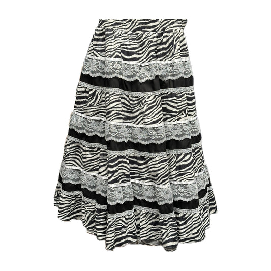 The ZEBRA Prairie Skirt by Square Up Fashions features black and white zebra stripes with horizontal lace trim, offering a chic update to the classic lace skirt style.
