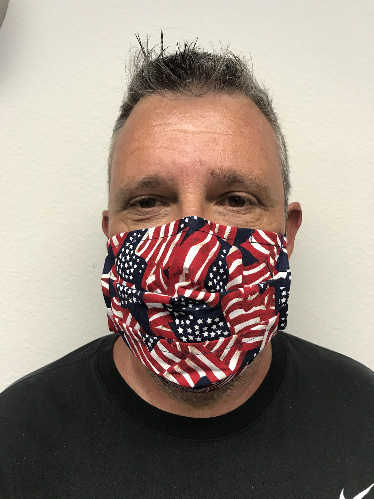 A man wearing a washable and reusable Square Up Fashions American flag face mask with adjustable nose wire.