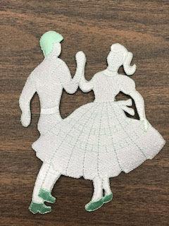 An image of a couple dancing on a table, surrounded by a variety of Square Dance Embroidered Patches in vibrant colors from Square Up Fashions.