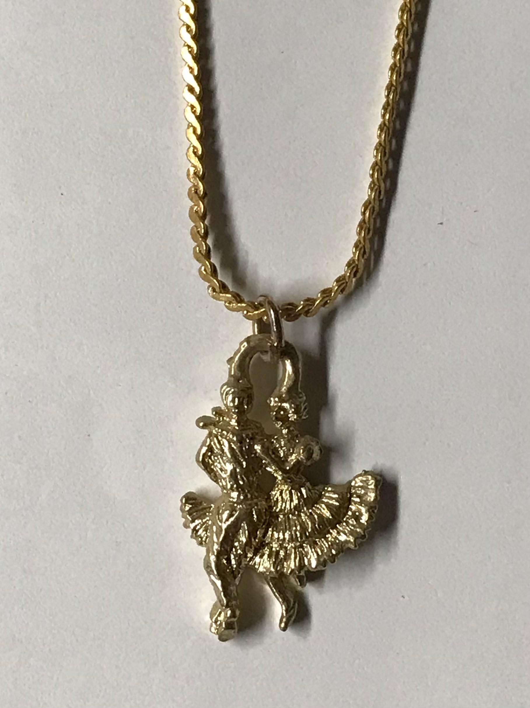 A thin Gold Dancers Necklace with a bird on it from Square Up Fashions.